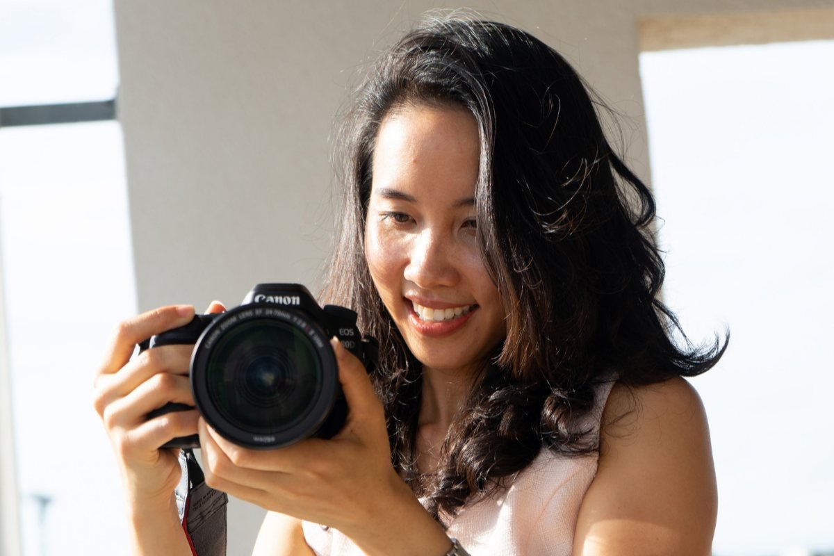 Holding my first professional camera, a Canon, in 2019