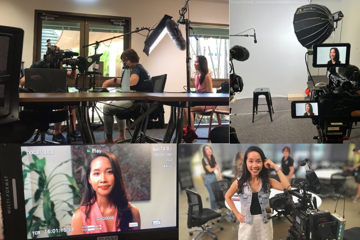 Being filmed in a boardroom, lit on a studio set, and standing beside a cinema camera