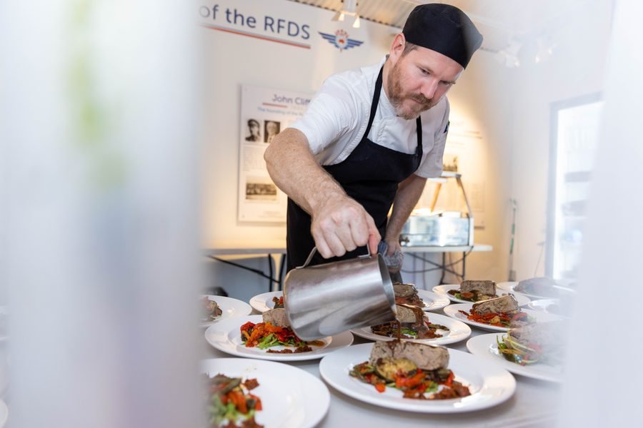 Chef plating the main course back of house