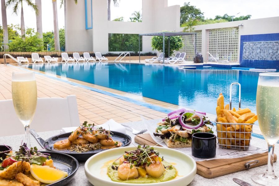 Poolside lunch plates and sparkling wine beside the hotel pool