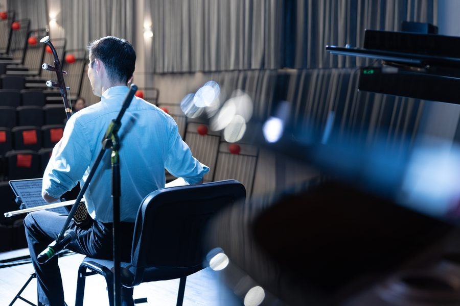 Musician performing on stage under the lights