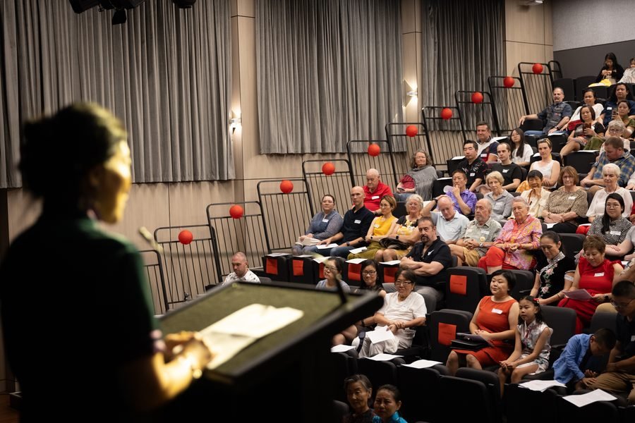 The audience watching from the tiered seating