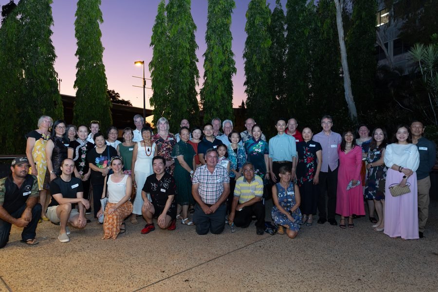 Guests and performers together outside at dusk
