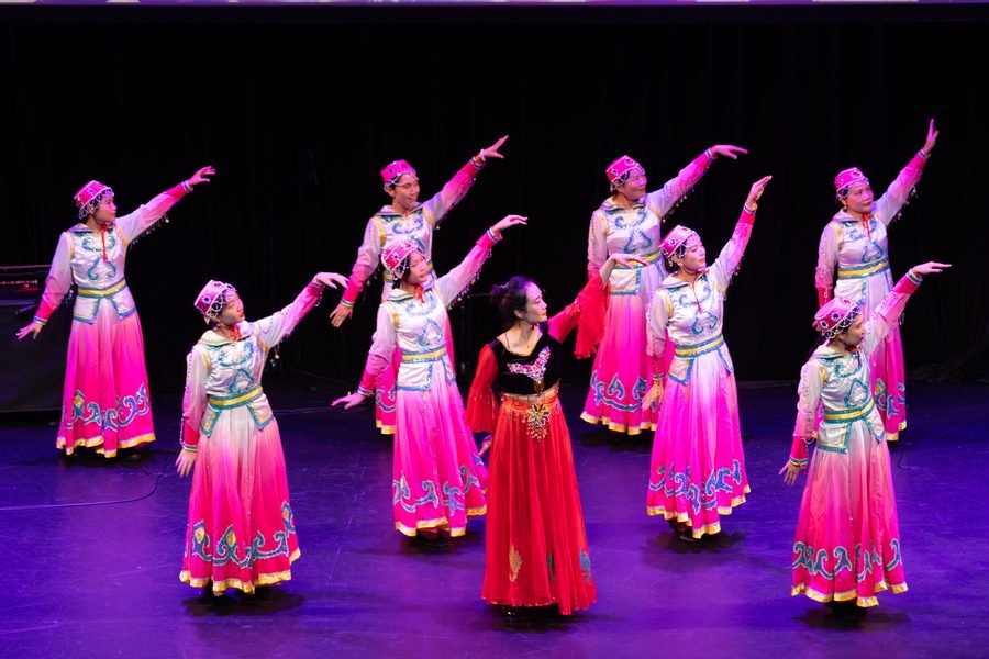 Dancers in pink taking their positions under the lights