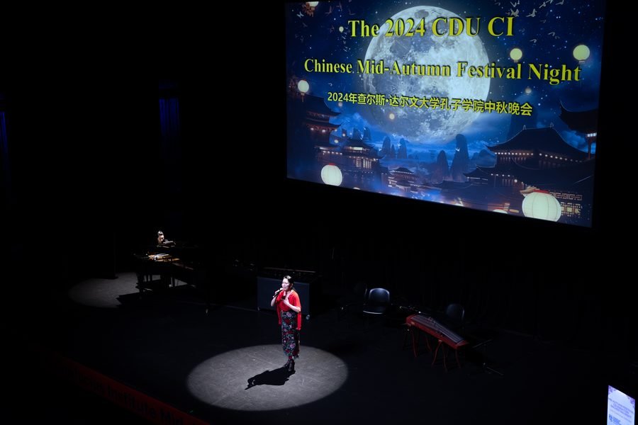 Host opening the evening beneath the festival title screen