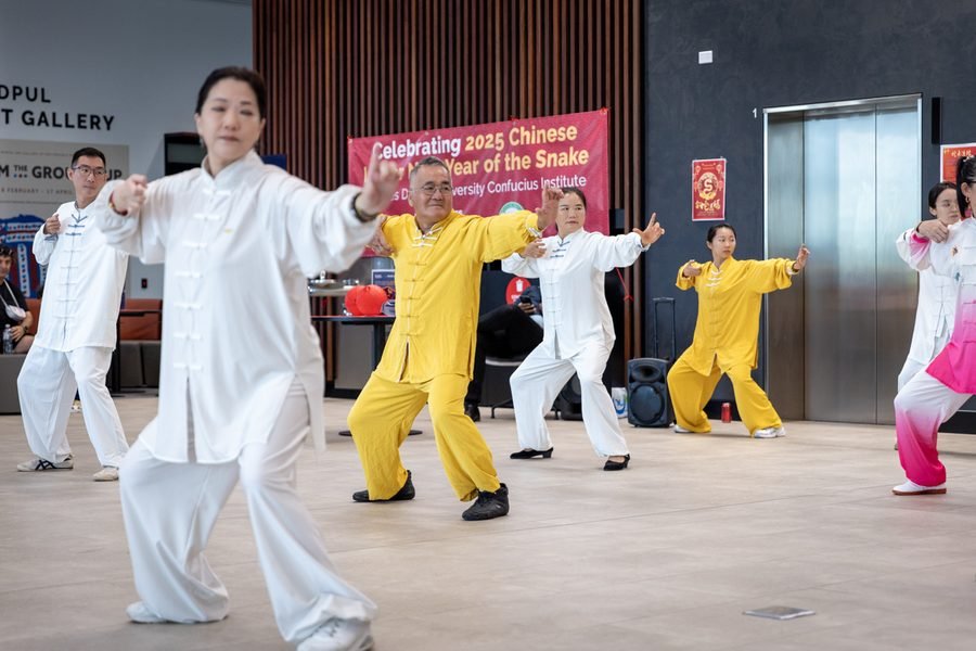 Group working through a tai chi form together