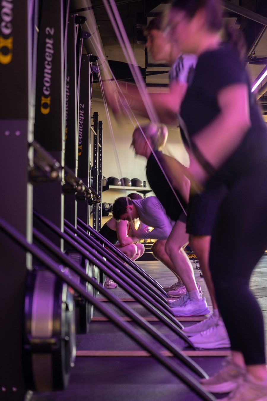 Members driving through a reformer set under violet light