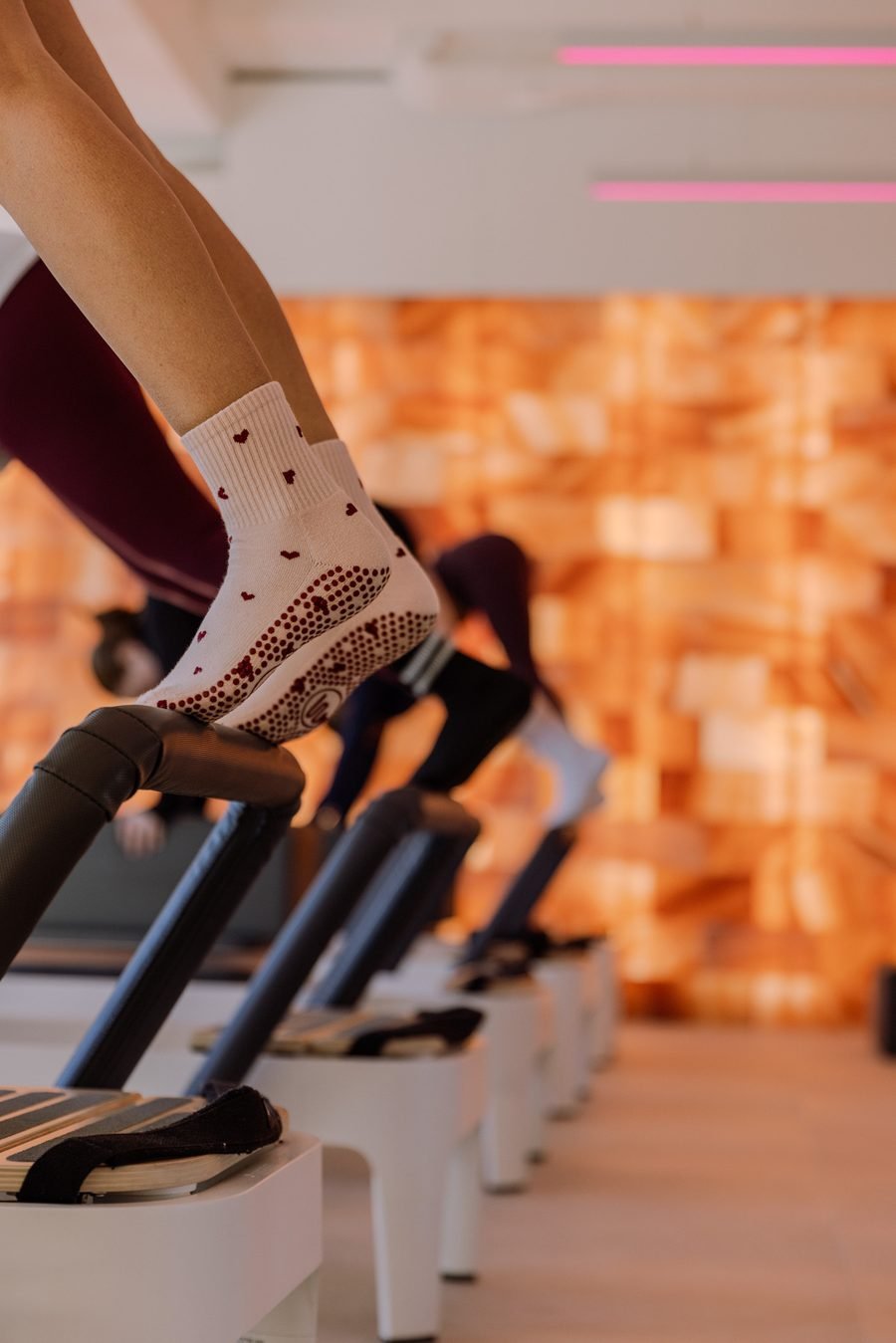 Close detail of grip socks braced against the reformer footbar