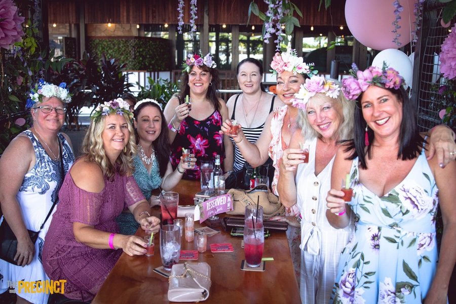 Table of guests lifting their glasses to camera