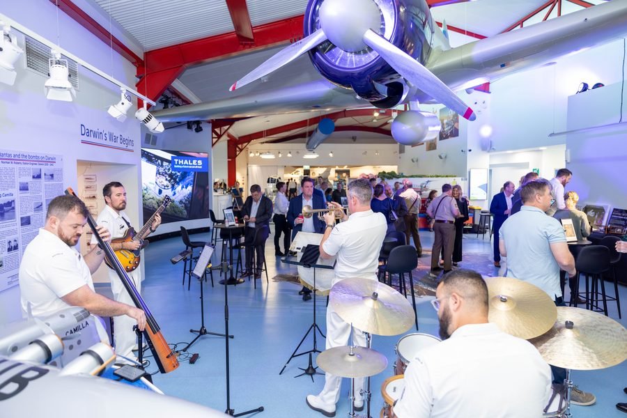 Ensemble performing beneath the suspended aircraft