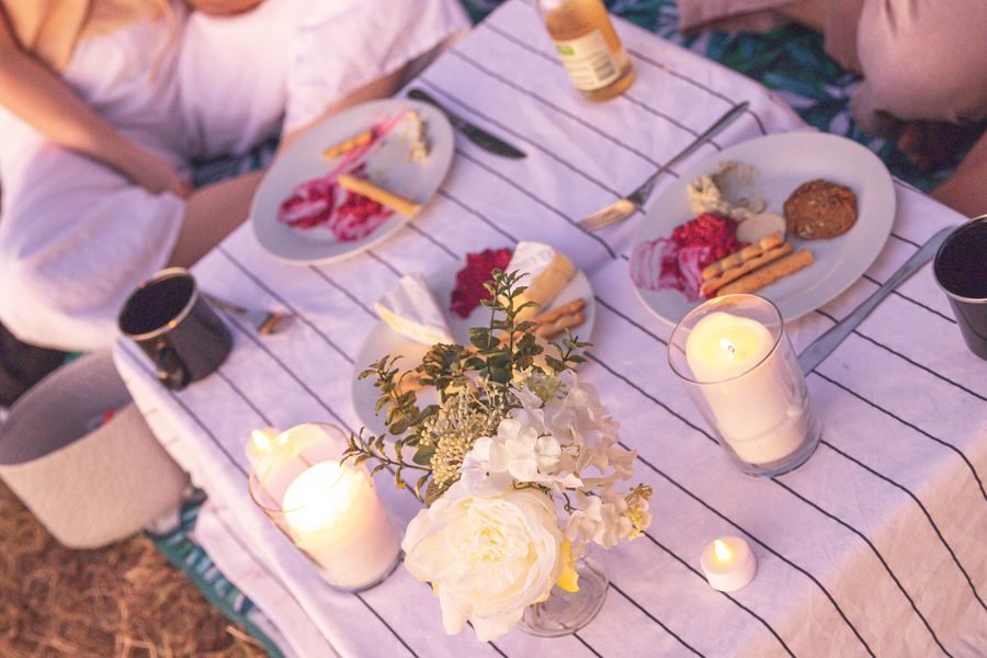 Overhead view of grazing plates, candles and blooms on the cloth