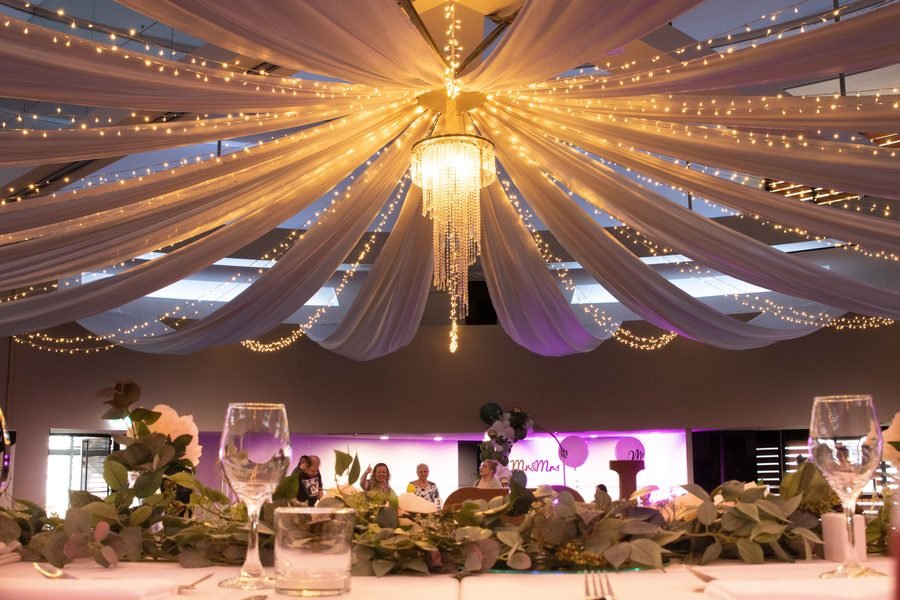 Ballroom dressed with drapery and chandeliers above the stalls